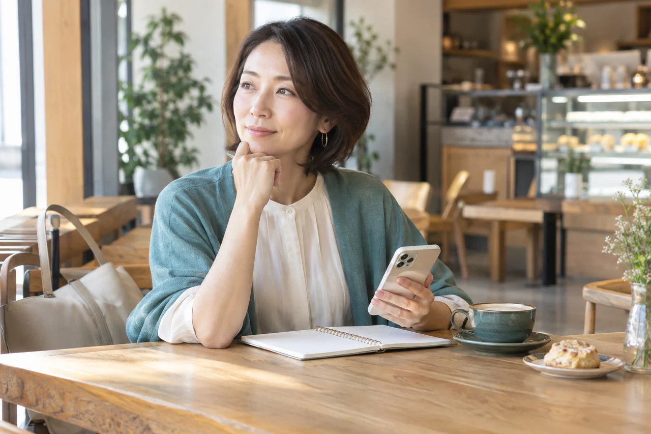 架空の40代女性が昼間の待ち合わせと帰宅計画をノートで確認する様子
