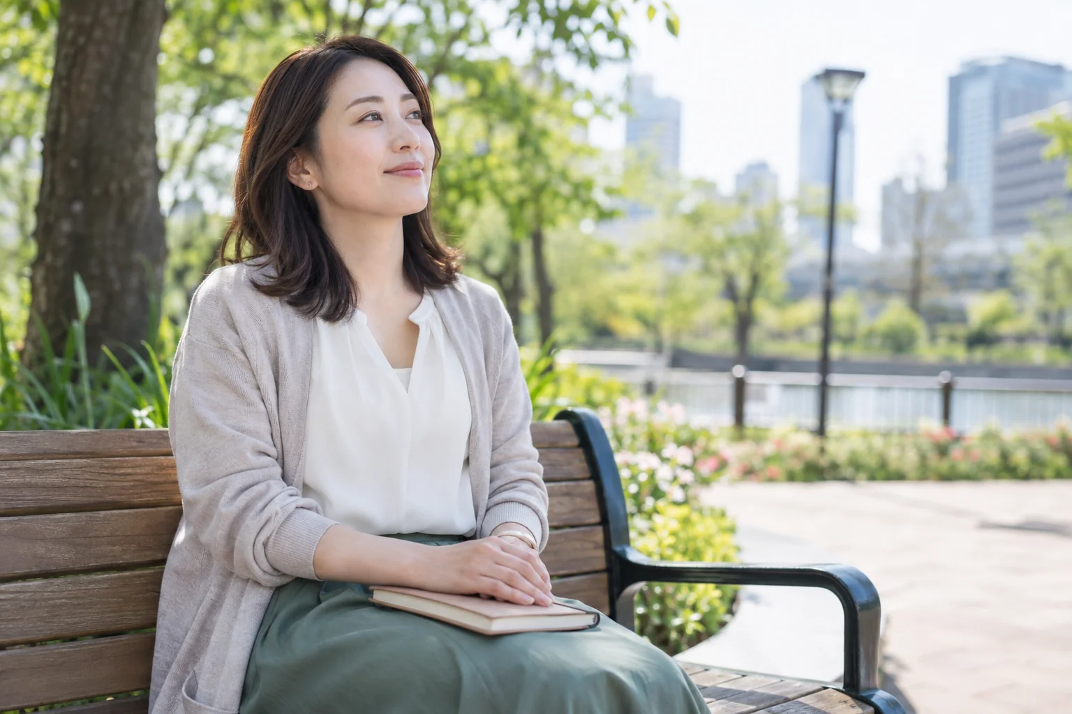 日本人女性が公園のベンチで静かに過ごす